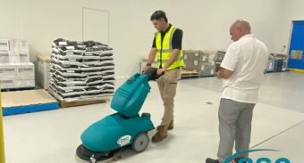 men with walk behind sweeper